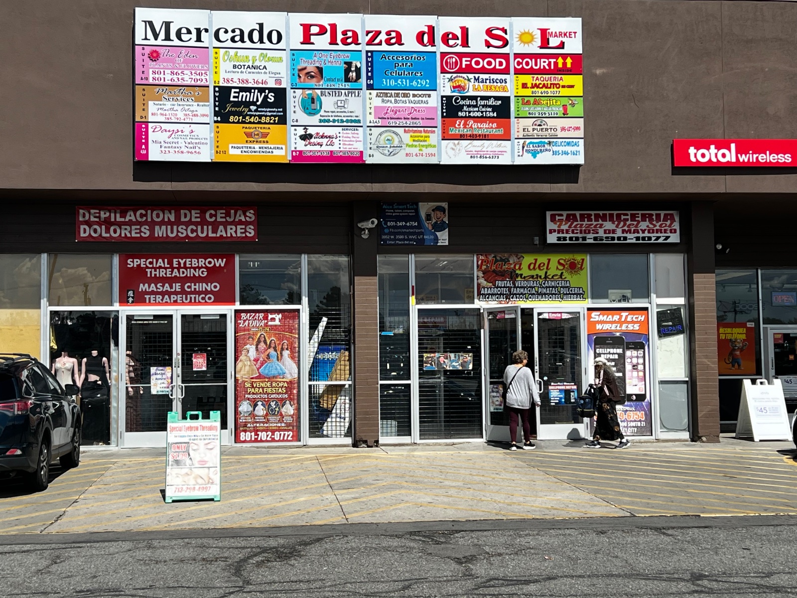 Plaza del Sol frontage with the cellphone repair window and REPAIR sign.